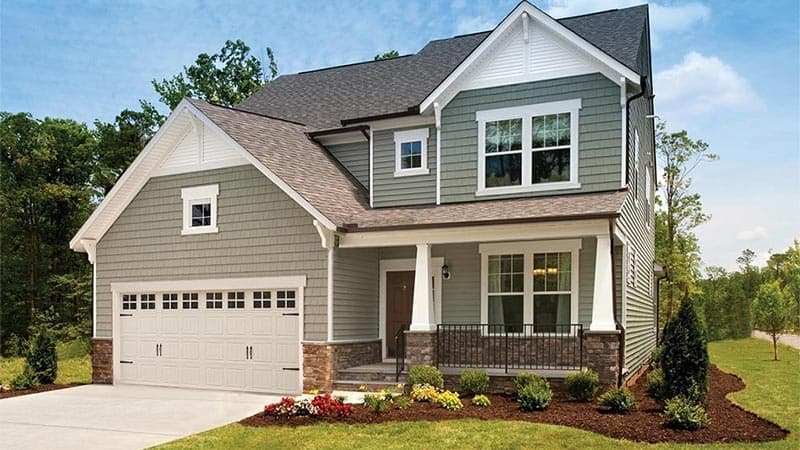 Two-story craftsman-style single-family home with covered porch and manicured front yard